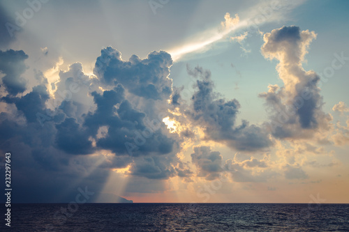 Wallpaper Mural Sun rays and dark clouds on sky at the sea before sunset in the evening Torontodigital.ca