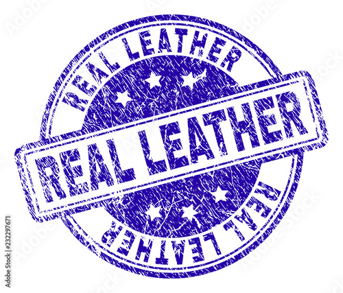 REAL LEATHER stamp seal imprint with grunge texture. Designed with rounded rectangles and circles. Blue vector rubber print of REAL LEATHER text with retro texture.