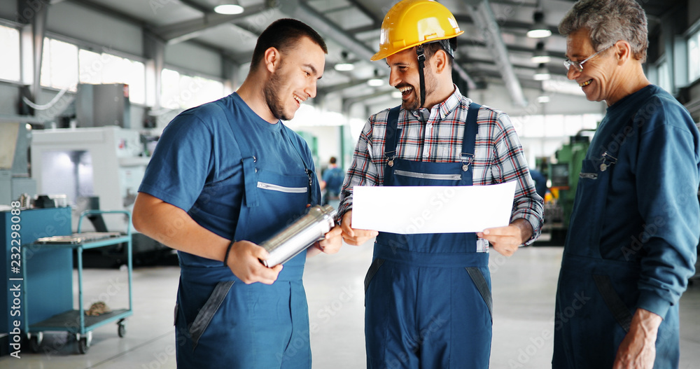 Team Of Engineers Having Discussion In Factory Team Of Engineers Having Discussion In Factory