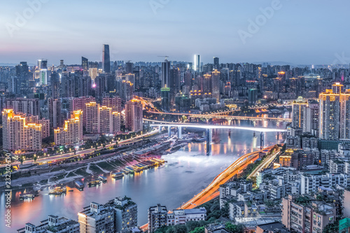 cityscape and skyline of downtown near water of chongqing at night photo