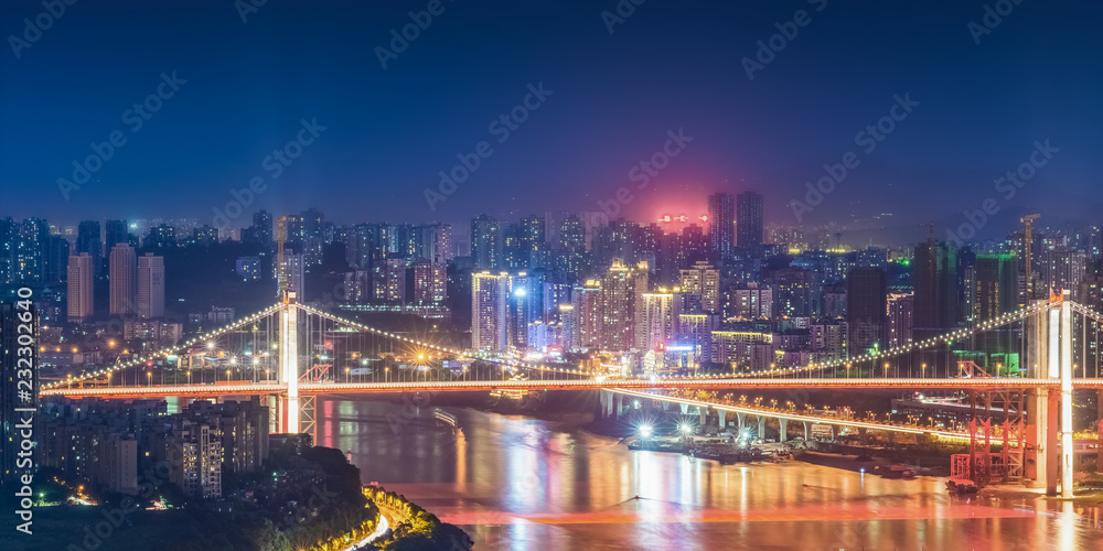 cityscape and skyline of downtown near water of chongqing at night