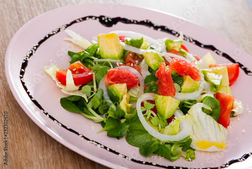 Salad of  avocado, tomatoes, grapefruit and corn salad at plate