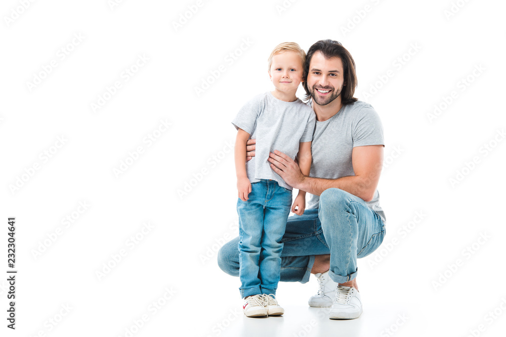 Father and son hugging and smiling isolated on white Father and son hugging and smiling isolated on white