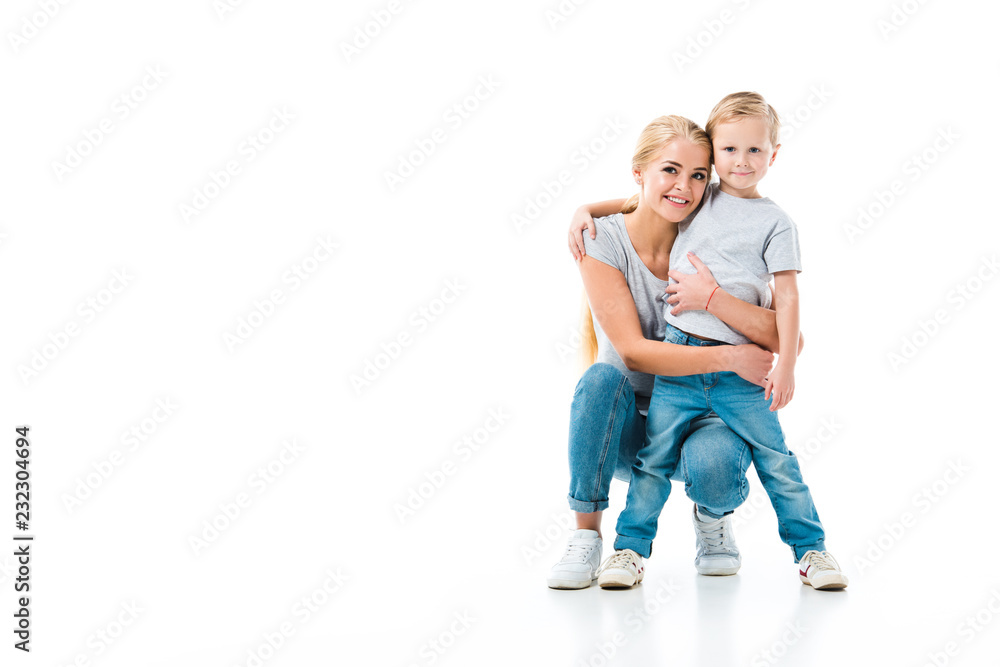 mother and her son hugging each other and looking at camera isolated on white mother and her son hugging each other and looking at camera isolated on white