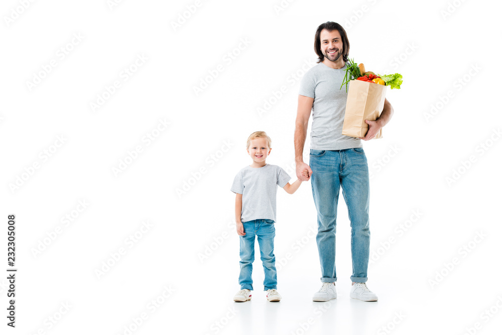Father and son after shopping with bag full of food isolated on white Father and son after shopping with bag full of food isolated on white