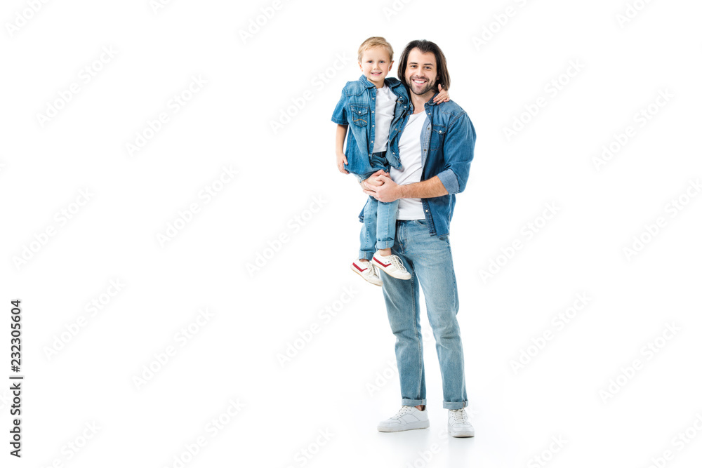 Father holding his pretty son and looking at camera isolated on white