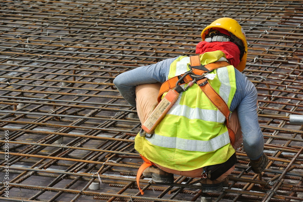 Construction workers fabricating steel reinforcement bar at the
