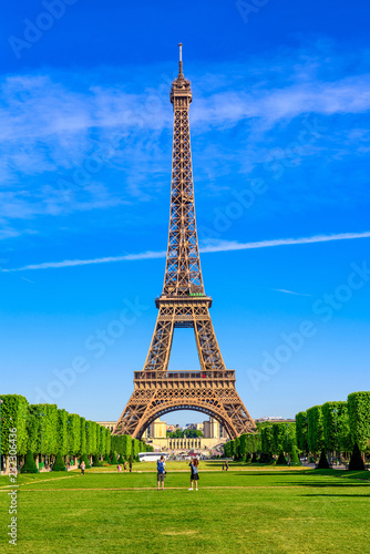 Paris Eiffel Tower and Champ de Mars in Paris, France. Eiffel Tower is one of the most iconic landmarks in Paris. The Champ de Mars is a large public park in Paris © Ekaterina Belova
