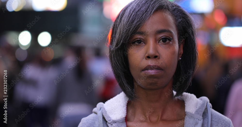 Woman in city at night serious face portrait Woman in city at night serious face portrait