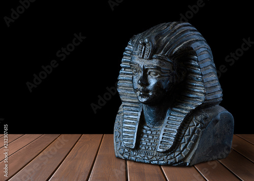 Egyptian pharaoh statue with sand background and sky