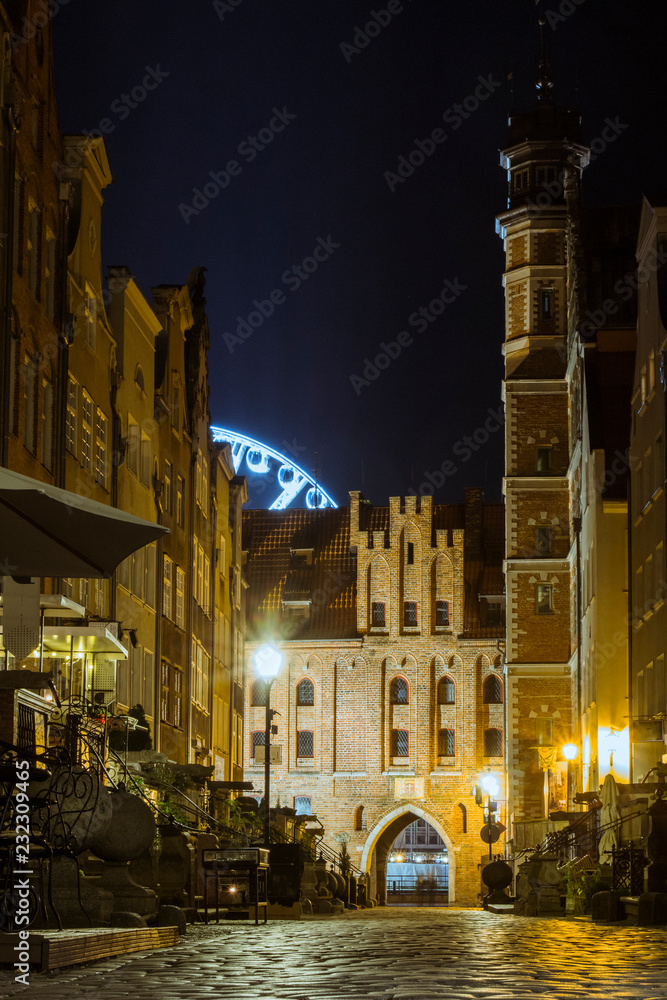Naklejka premium Narrow historic street in the Old Town of Gdansk at night. Poland