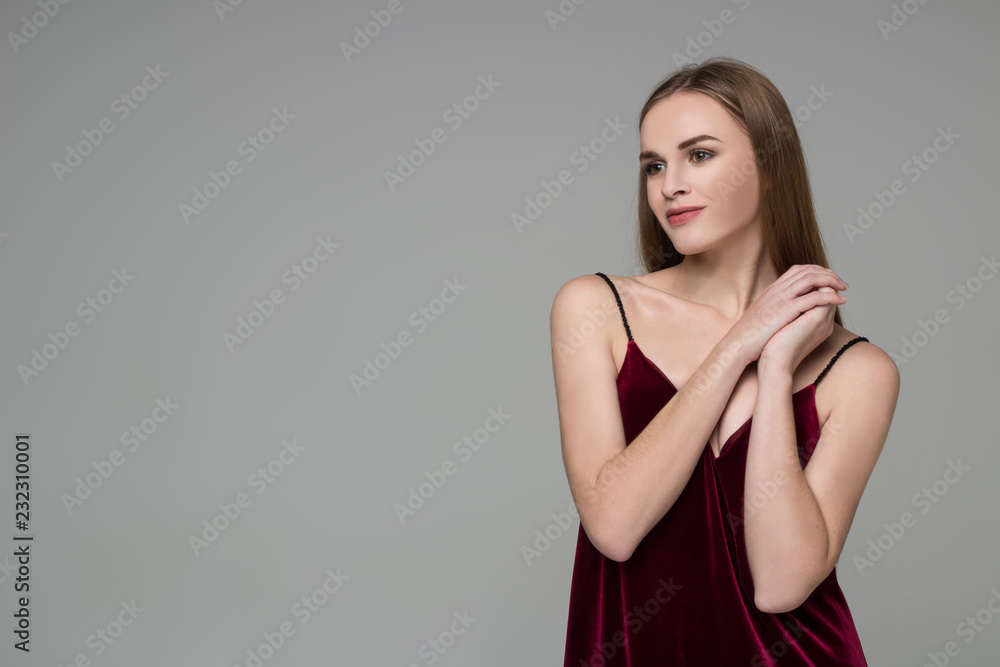 Young blond girl in dark red dress showing emotions: pleasure Young blond girl in dark red dress showing emotions: pleasure