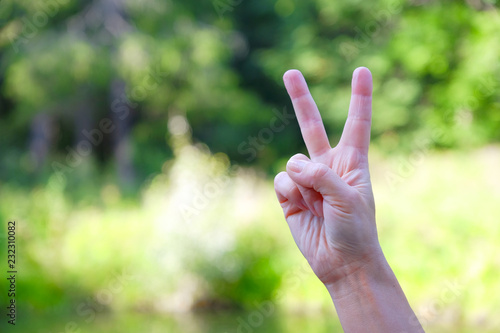 Two fingers up is a common gesture meaning victory or peace. © Андрей Михайлов