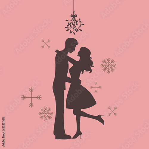 Silhouette of couple are kissing under the mistletoe