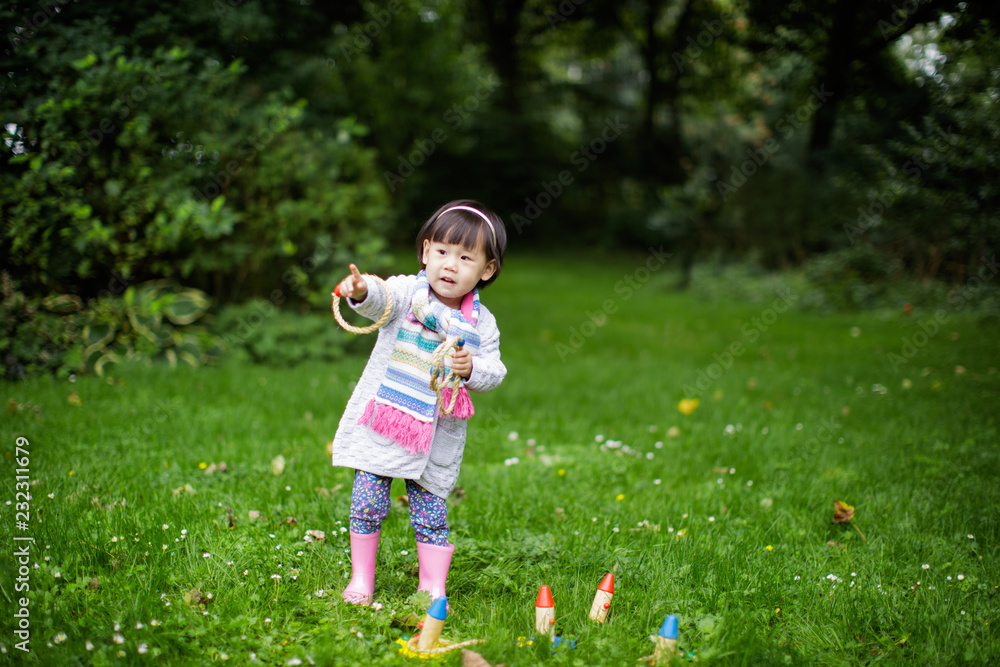 toddler baby girl play  ferrule toy ringer circles in Spring forest park