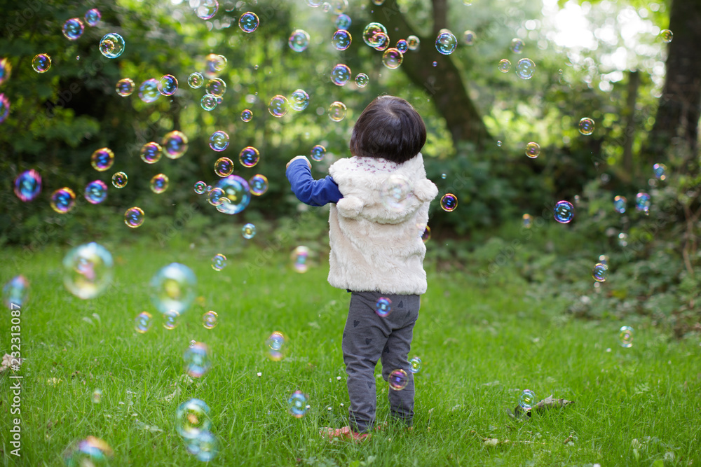 toddle baby girl play bubble at Spring garden toddle baby girl play bubble at Spring garden