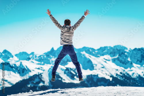 Joyful man celebrating in a snowy winter landscape