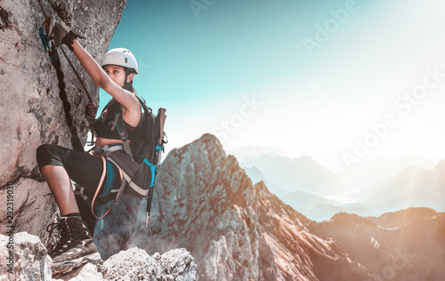 Young woman climbing in the alps