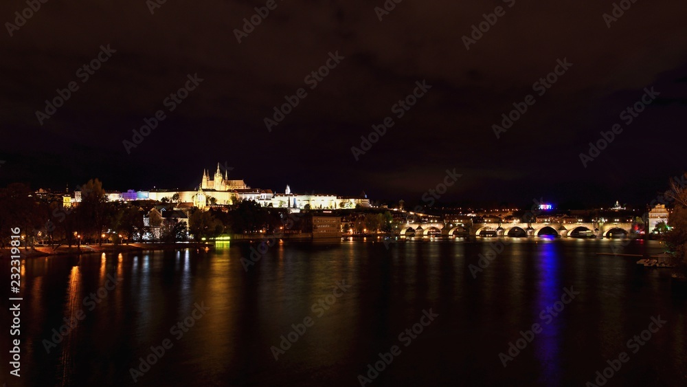 A panoramic view Prague Castle, the Charles Bridge and the Vltava River in the beautiful city of Prague, Czech Republic - Europe. A beautiful night photo of the architecture of the capital.