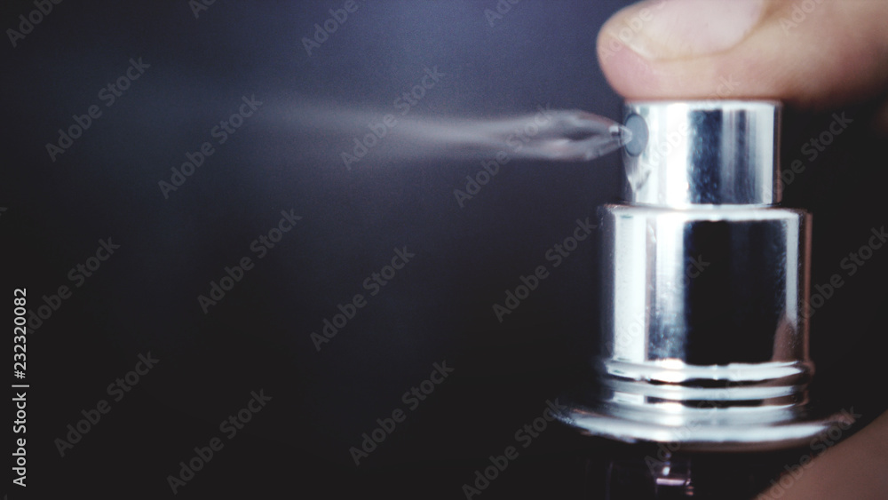 Spray bottle drops like perfume on a black background Spray bottle drops like perfume on a black background