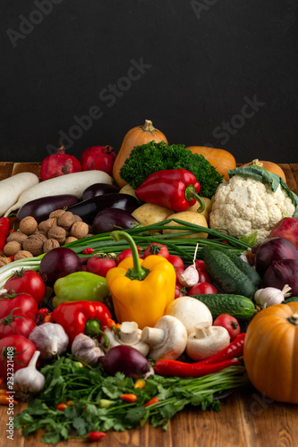 Vegetables and nuts on a brown wooden background