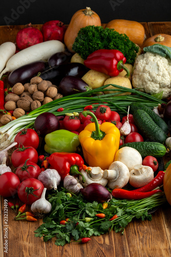 Vegetables and nuts on a brown wooden background