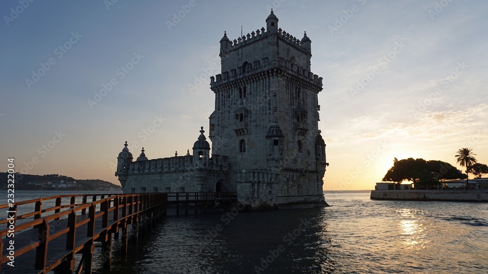 sunset at the tower of belem in lisbon