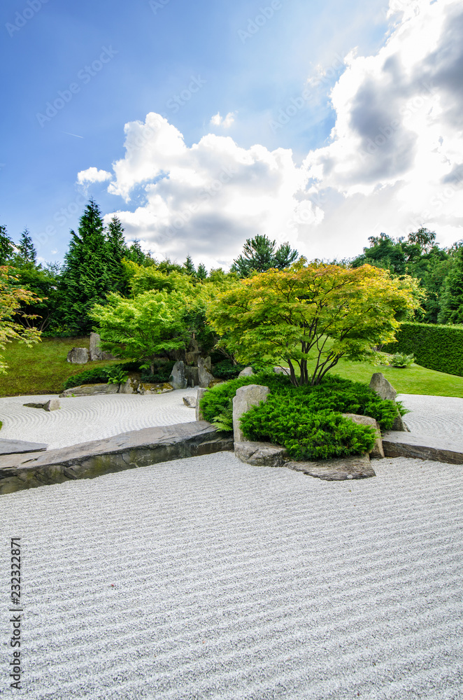 traditional japanese zen garden with trees in the background