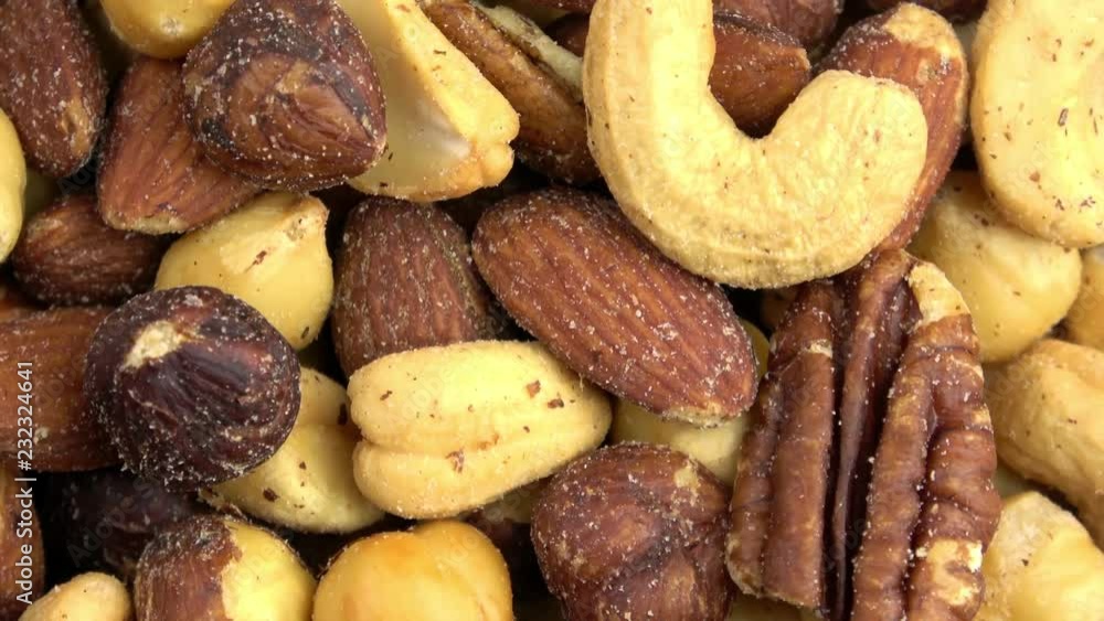 Roasted salted assorted nut mix spinning video close up Roasted salted assorted nut mix spinning video close up