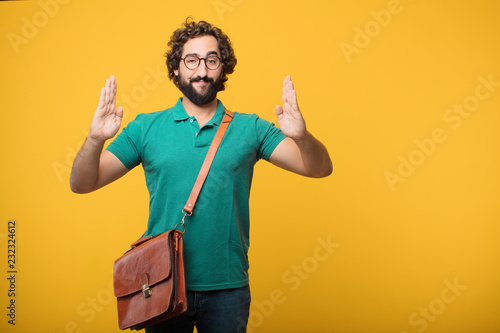 young freelancer man expresing a concept against orange isolated photo