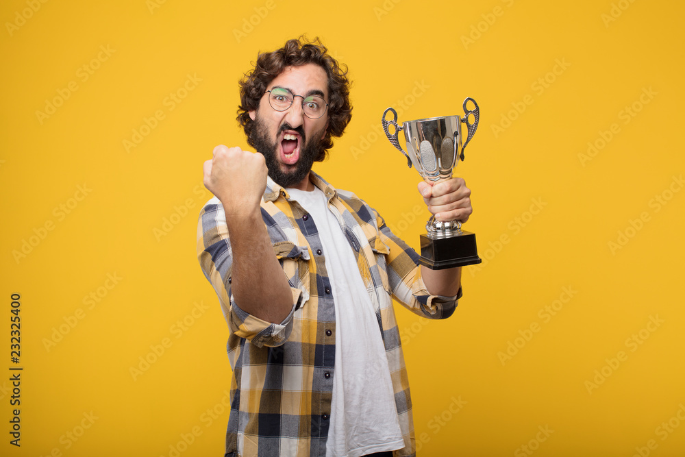 Fotografie young crazy mad man  fool pose with a trophy.