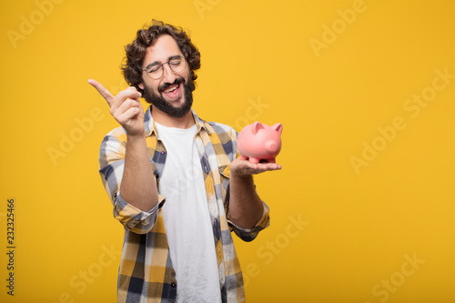 young crazy mad man  fool pose with a piggy bank. savings concep photo