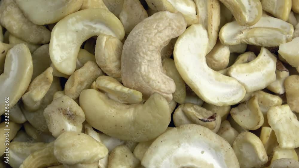 Raw unshelled cashew pieces spinning video close up Raw unshelled cashew pieces spinning video close up