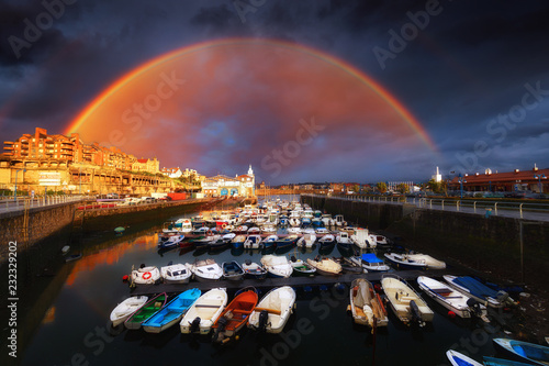 Marina of Getxo with stormy clouds and rainbow photo