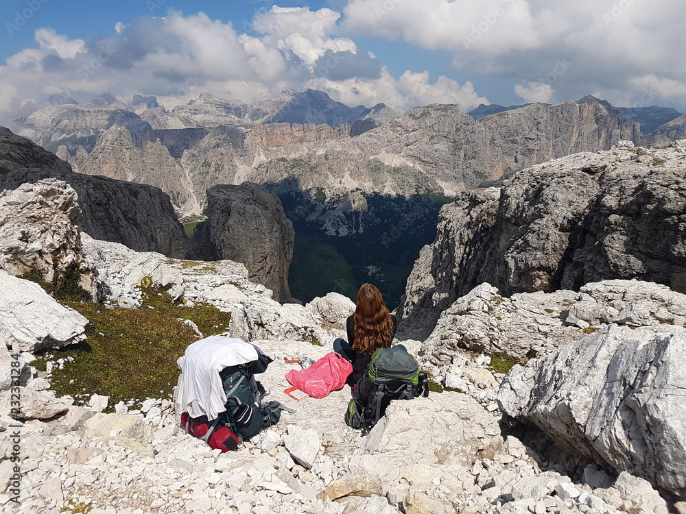 Successful hiking woman backpacker enjoy the view on mountain peak in the alps. Successful hiking woman backpacker enjoy the view on mountain peak in the alps.