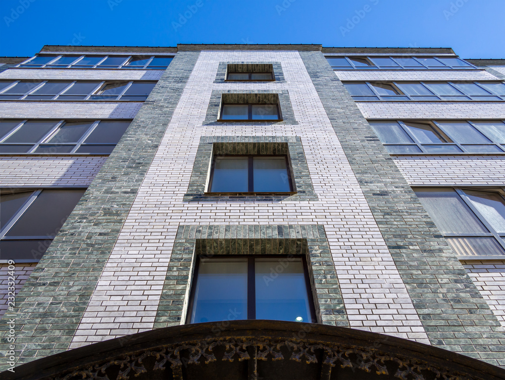 Fragment of the facade of a modern five-story brick apartment building Fragment of the facade of a modern five-story brick apartment building