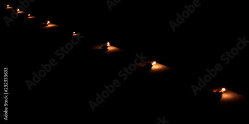 Earthen diya lamp lighting with candles on the occasion of diwali and sandhi pujo.