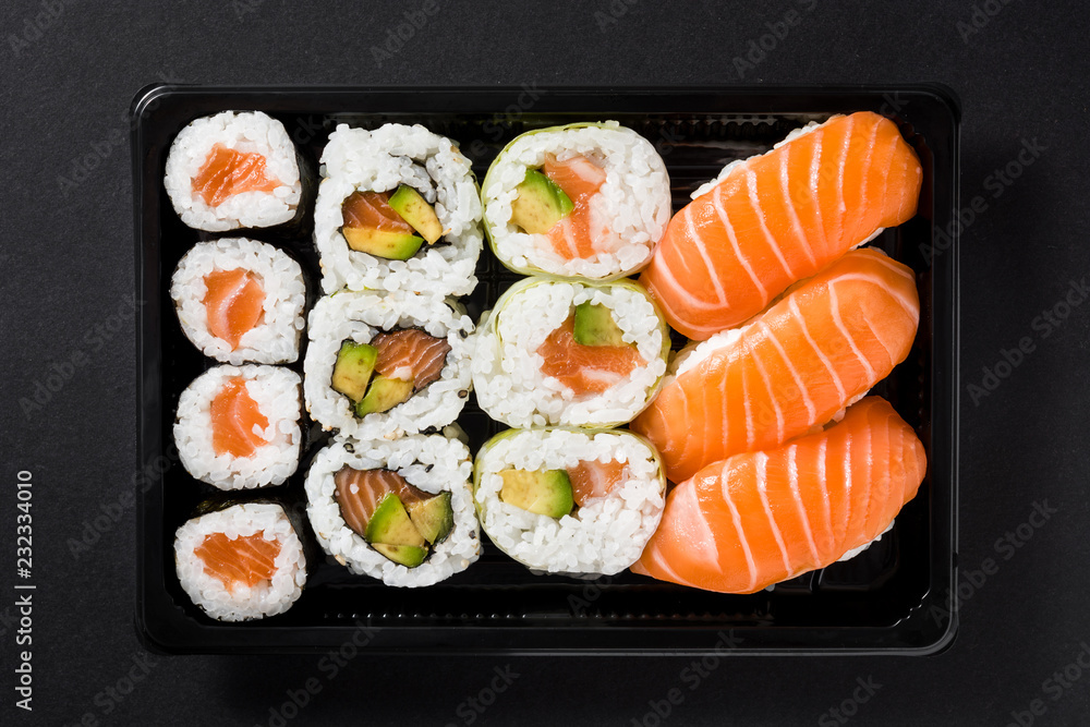 Japanese food: maki and nigiri sushi set on black background. Top view Japanese food: maki and nigiri sushi set on black background. Top view