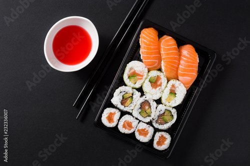 Maki and nigiri sushi set on black background