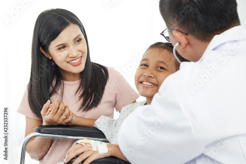 Asian male doctor talking to young child wheelchair and mother, Concept hospital care, Health Insurance