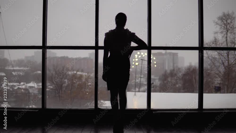 business woman comes to the window in the office. 4k business woman comes to the window in the office. 4k
