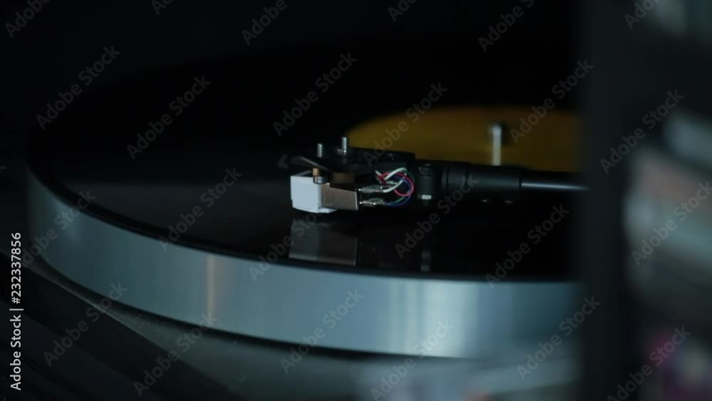 Close up of record player arm as LP plays Close up of record player arm as LP plays