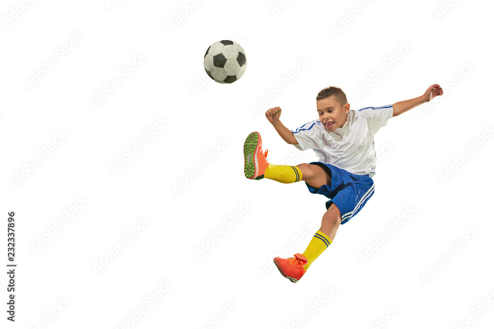 Young boy with soccer ball doing flying kick