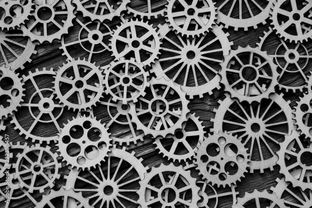 a lot of gears on a wooden background. the concept of mechanism, interaction, logical thinking. a lot of gears on a wooden background. the concept of mechanism, interaction, logical thinking.