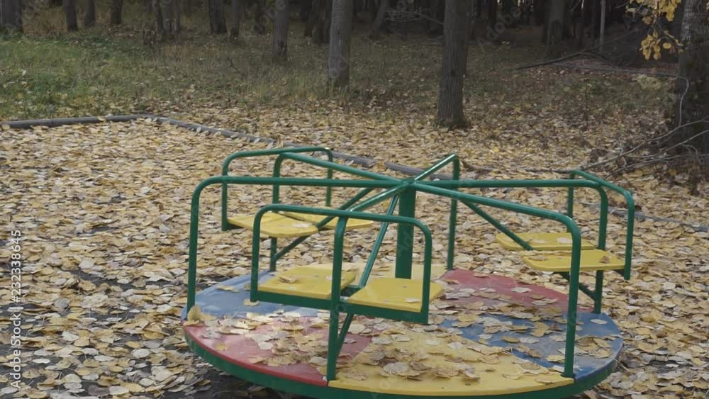 Old carousel is spinning against the background of the forest. Empty children's swing. 1920X1080 Full Hd. Old carousel is spinning against the background of the forest. Empty children's swing. 1920X1080 Full Hd.