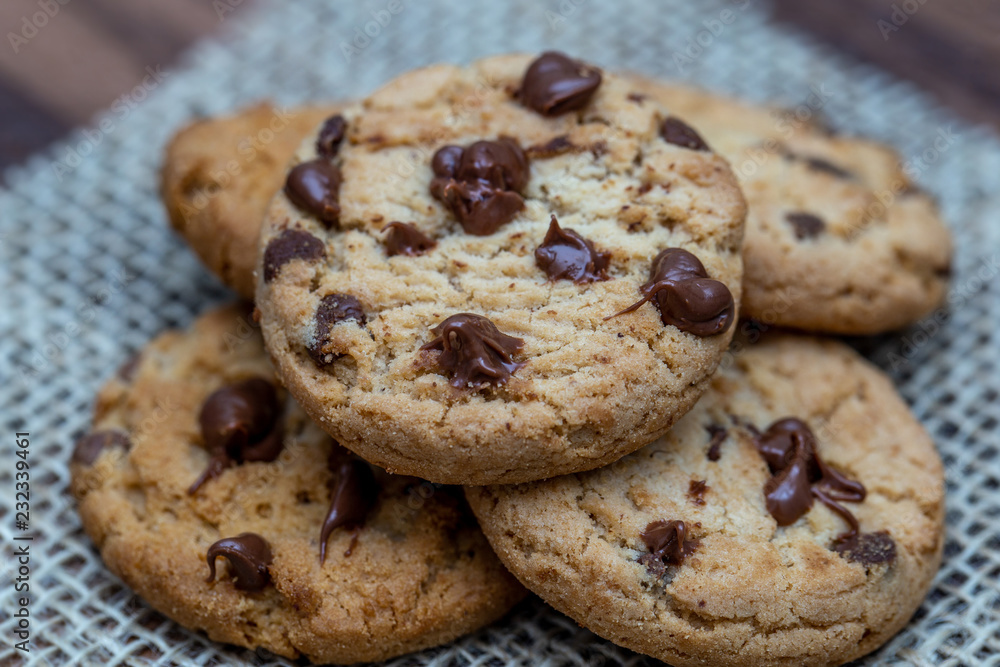 delicious cookie with chocolate drops, over wooden table and rustic tin. delicious cookie with chocolate drops, over wooden table and rustic tin.