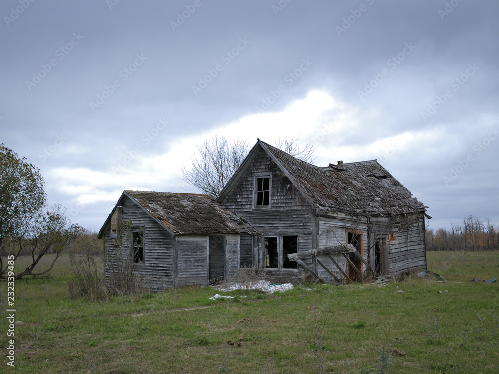 Dreary Abandoned Dilapidated Farm House with cloud skies in northern Minnesota Dreary Abandoned Dilapidated Farm House with cloud skies in northern Minnesota
