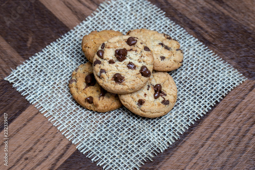  delicious cookie with chocolate drops  over wooden table and rustic tin.