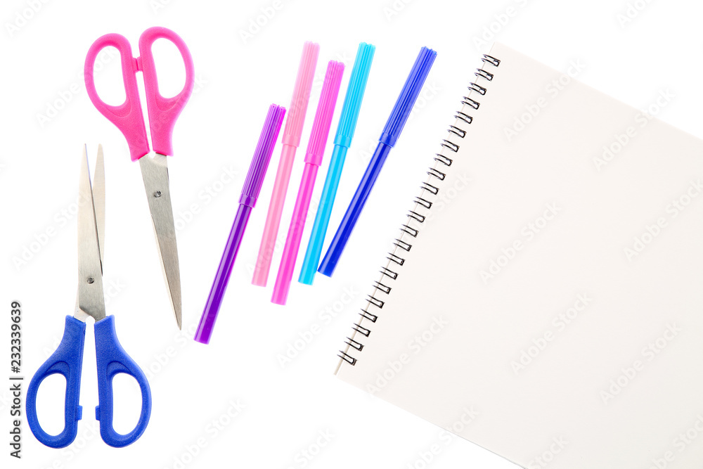 Two scissors, five felt tip pens in pink, blue and purple colors and blank sketchbook, isolated on white background. Space for text on the pad sheet. Art and creativity concept Two scissors, five felt tip pens in pink, blue and purple colors and blank sketchbook, isolated on white background. Space for text on the pad sheet. Art and creativity concept