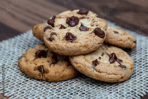  delicious cookie with chocolate drops, over wooden table and rustic tin.